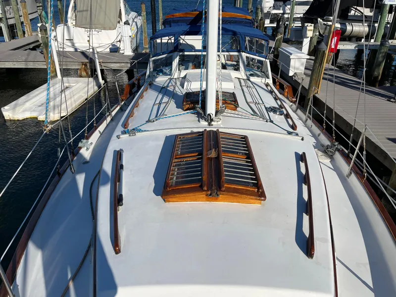 Slide: The Image of Deck of a 1990 Gozzard 36 sailboat docked at a marina. - 10