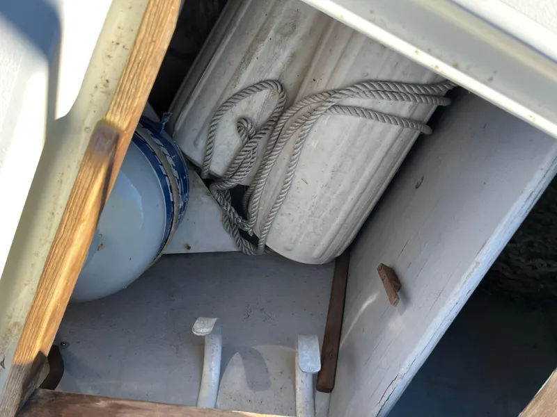 Slide: The Image of Storage compartment on a 1990 Gozzard 36 sailboat with ropes and fenders. - 12