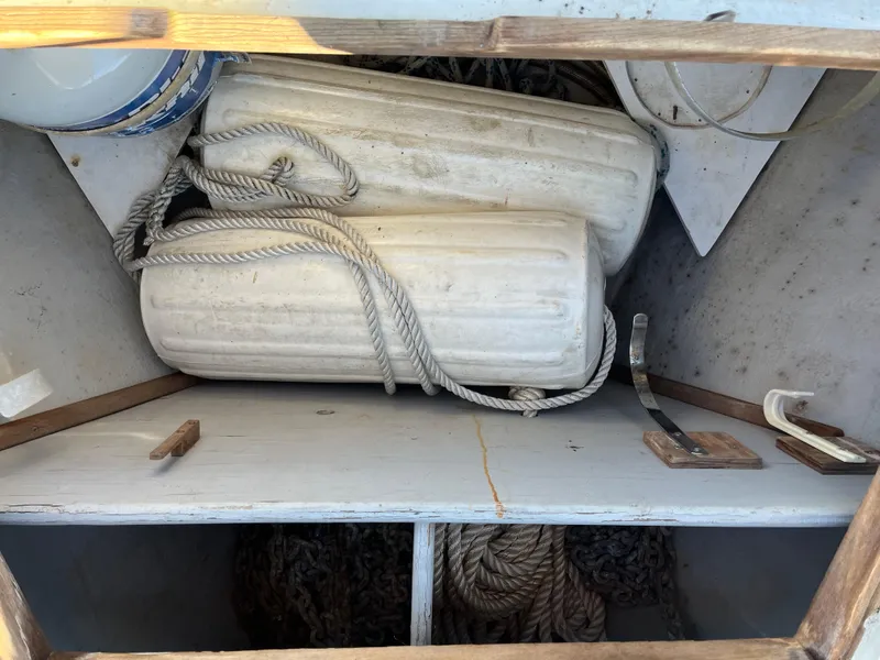 Slide: The Image of Storage compartment of a 1990 Gozzard 36 sailboat with fenders and ropes. - 13