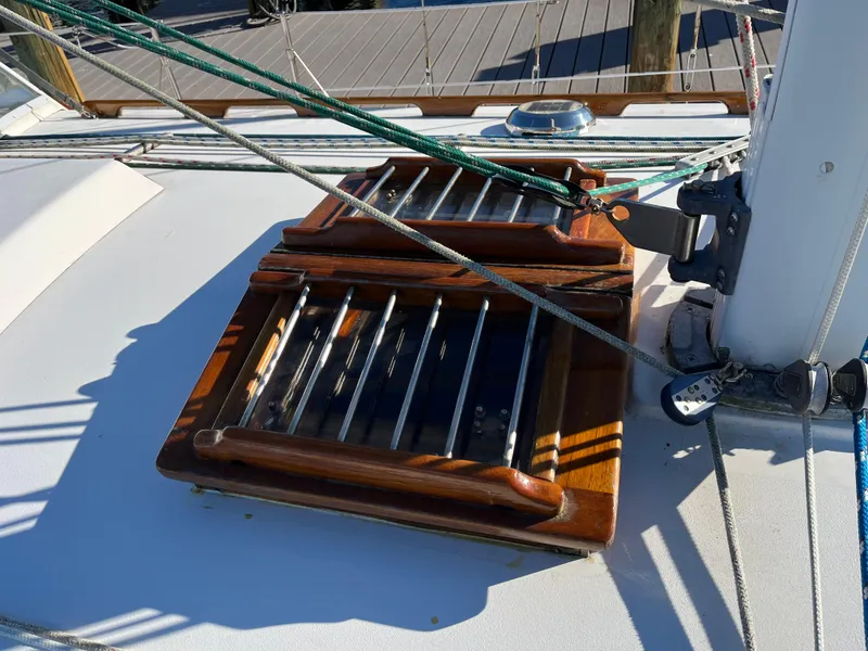 Slide: The Image of Wooden hatch on 1990 Gozzard 36 sailboat deck with rigging lines. - 16