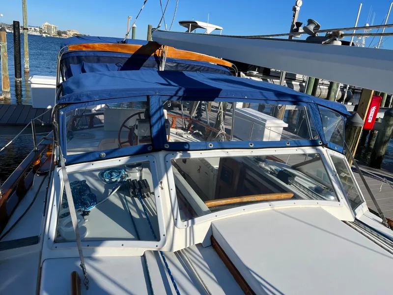 Slide: The Image of 1990 Gozzard 36 sailboat docked with blue canvas cover. - 17