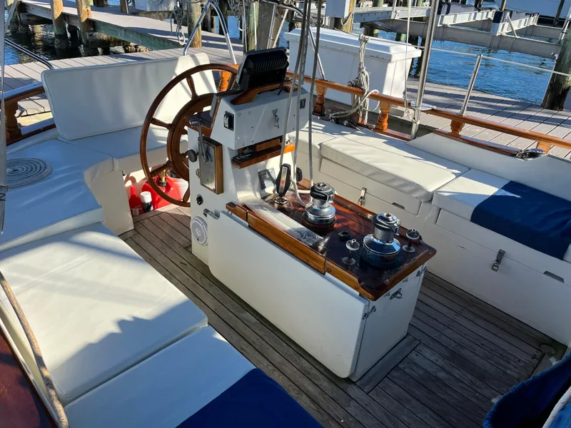Slide: The Image of Cockpit of a 1990 Gozzard 36 sailboat with wooden wheel and seating. - 18