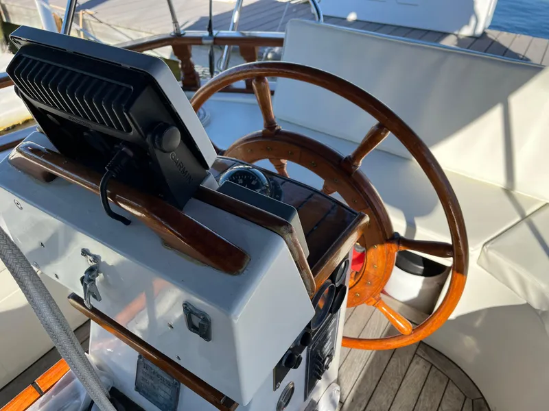 Slide: The Image of Cockpit of a 1990 Gozzard 36 sailboat with wooden steering wheel and navigation equipment. - 21