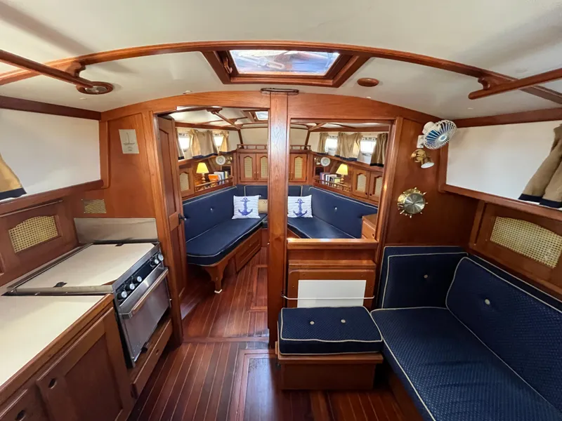 Slide: The Image of Interior of 1990 Gozzard 36 sailboat with wooden finishes and blue upholstery. - 40