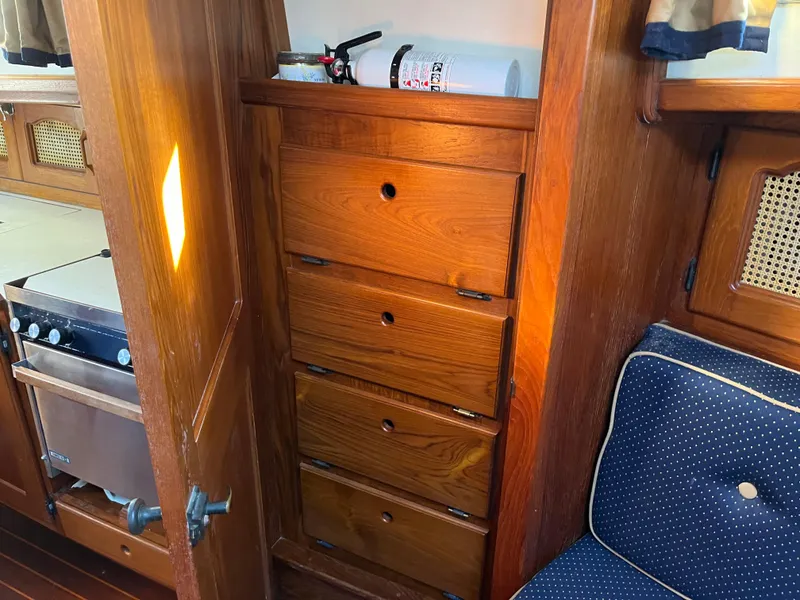 Slide: The Image of Interior of 1990 Gozzard 36 sailboat with wooden drawers and fire extinguisher. - 45