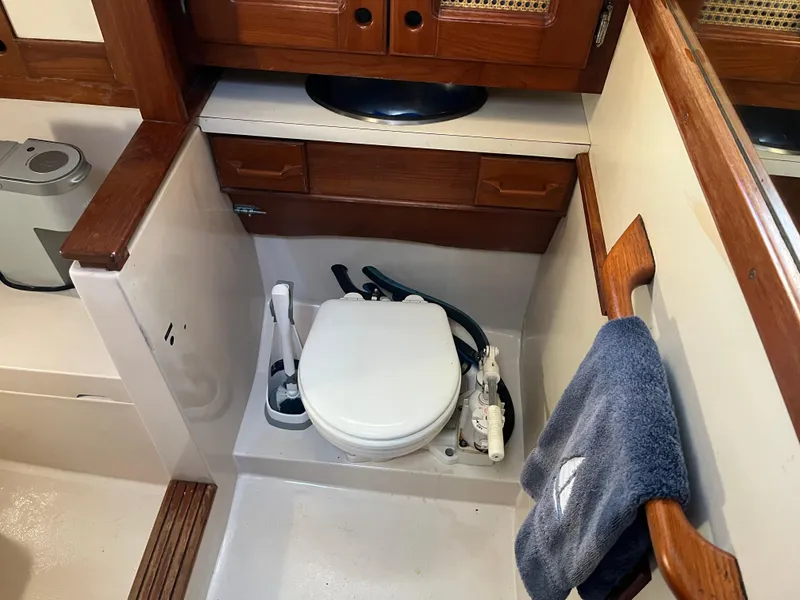 Slide: The Image of 1990 Gozzard 36 sailboat bathroom with marine toilet and wooden cabinetry. - 48