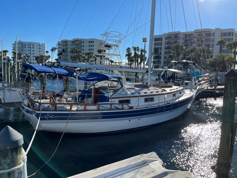 Slide: The Image of Gozzard 36 sailboat docked at marina, 1990 model, sunny day with waterfront buildings. - 6