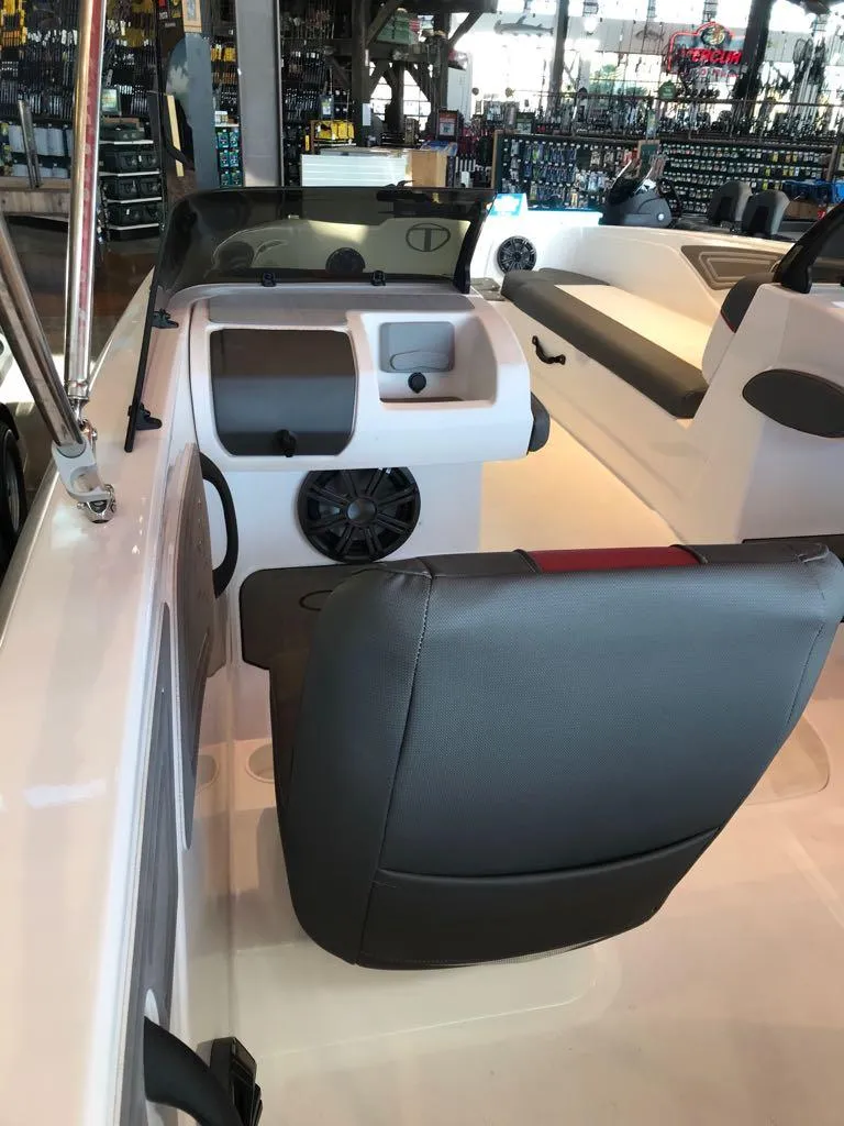 Slide: The Image of 2024 Tahoe T21 boat interior with seating and dashboard view. - 10