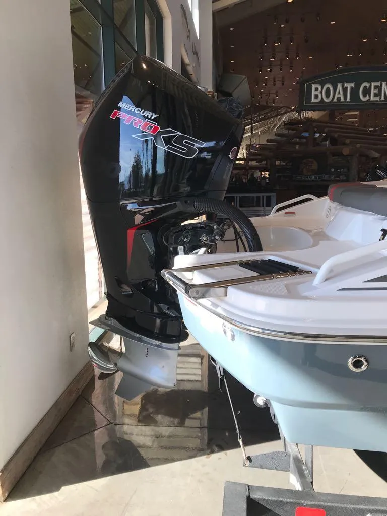 Slide: The Image of 2024 Tahoe T21 boat with Mercury Pro XS engine at a boat center. - 4