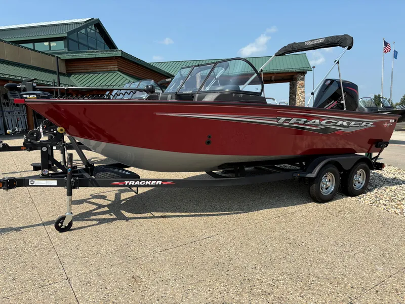 The Image of 2024 Tracker Targa V-19 WT boat on trailer, red exterior, parked outdoors. - 0