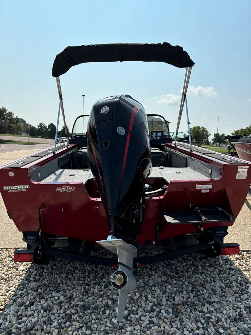Slide: The Image of 2024 Tracker Targa V-19 WT boat, rear view, parked on gravel. - 3