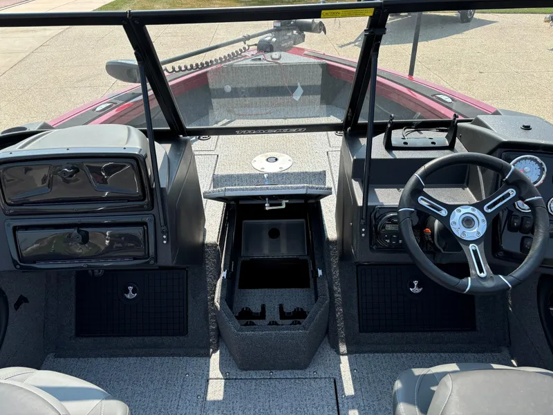 Slide: The Image of 2024 Tracker Targa V-19 WT boat interior with steering wheel and dashboard controls. - 5