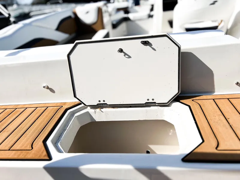 Slide: The Image of 2024 Starcraft SVX 211 OB boat storage compartment with open hatch. - 10