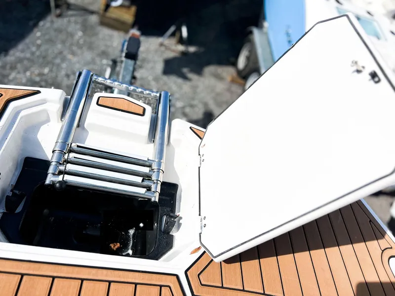 Slide: The Image of 2024 Starcraft SVX 211 OB boat with a folded ladder in storage compartment. - 12