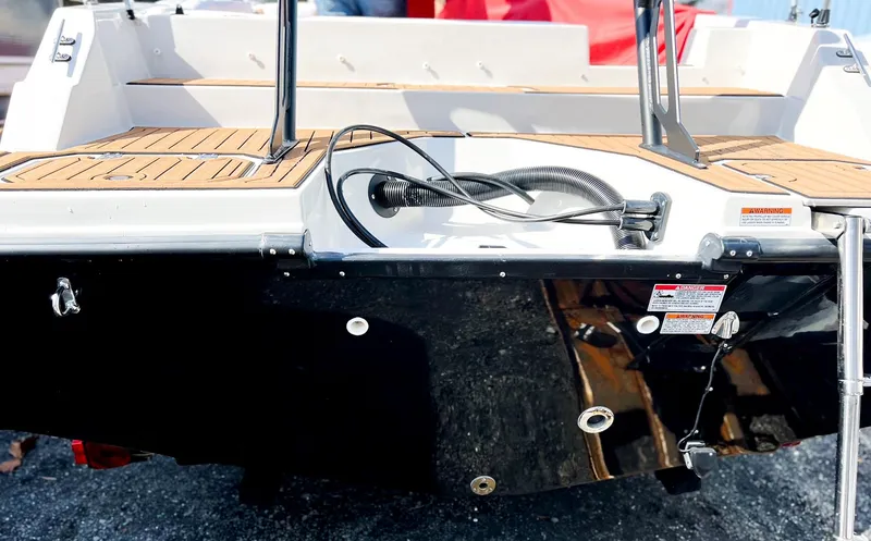 Slide: The Image of 2024 Starcraft SVX 211 OB boat stern with teak flooring and black hull. - 13