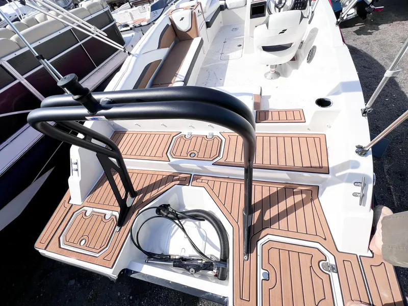Slide: The Image of 2024 Starcraft SVX 211 OB boat interior with teak flooring and seating area. - 4