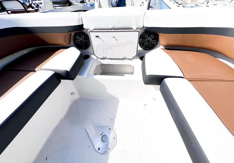 Slide: The Image of Interior seating of 2024 Starcraft SVX 211 OB boat with brown and white upholstery. - 6