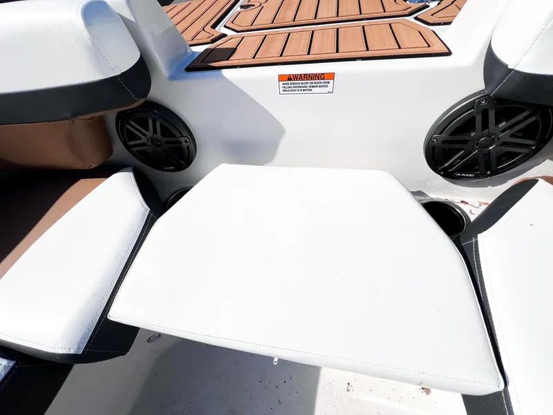 Slide: The Image of 2024 Starcraft SVX 211 OB boat seating area with cup holders and speakers. - 8