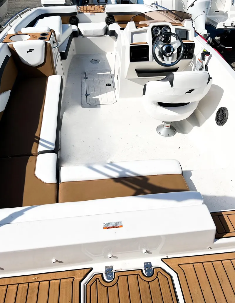 Slide: The Image of 2024 Starcraft SVX 211 OB boat interior with white and brown seating. - 9