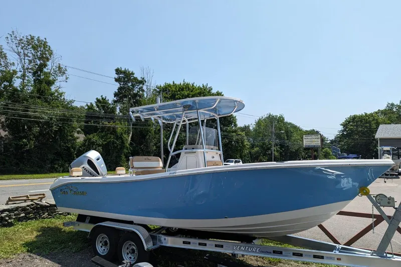 Slide: The Image of 2023 Sea Chaser 24 HFC boat on a trailer, parked outdoors. - 0
