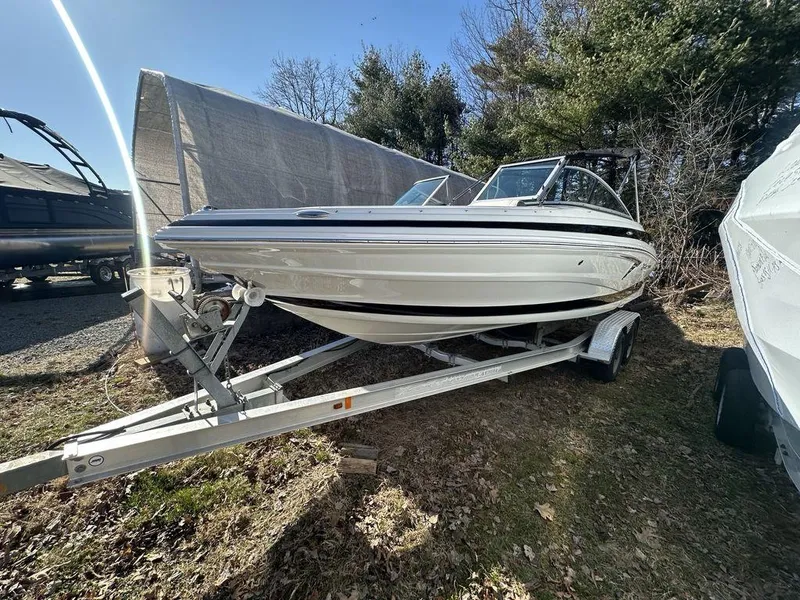 Slide: The Image of 2024 Crownline SS Series 220 boat on a trailer in an outdoor setting. - 1