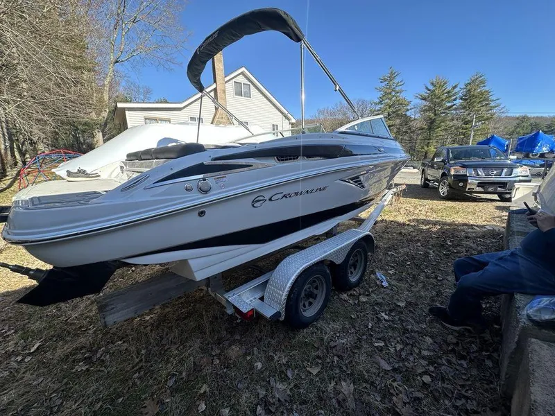 Slide: The Image of 2024 Crownline SS Series 220 boat on a trailer in a residential area. - 3