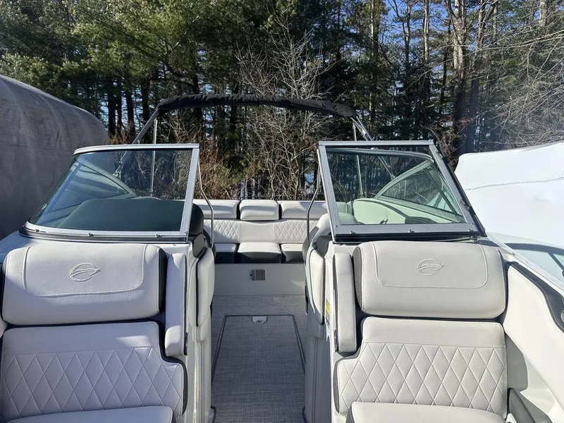 Slide: The Image of 2024 Crownline SS Series 220 boat interior with luxurious seating and open windshield. - 7