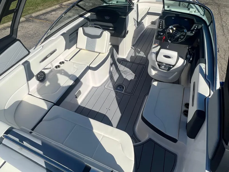 Slide: The Image of 2024 Chaparral 247 SSX boat interior with sleek seating and modern dashboard. - 2