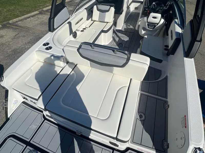 Slide: The Image of 2024 Chaparral 247 SSX boat interior with white seating and modern design. - 6