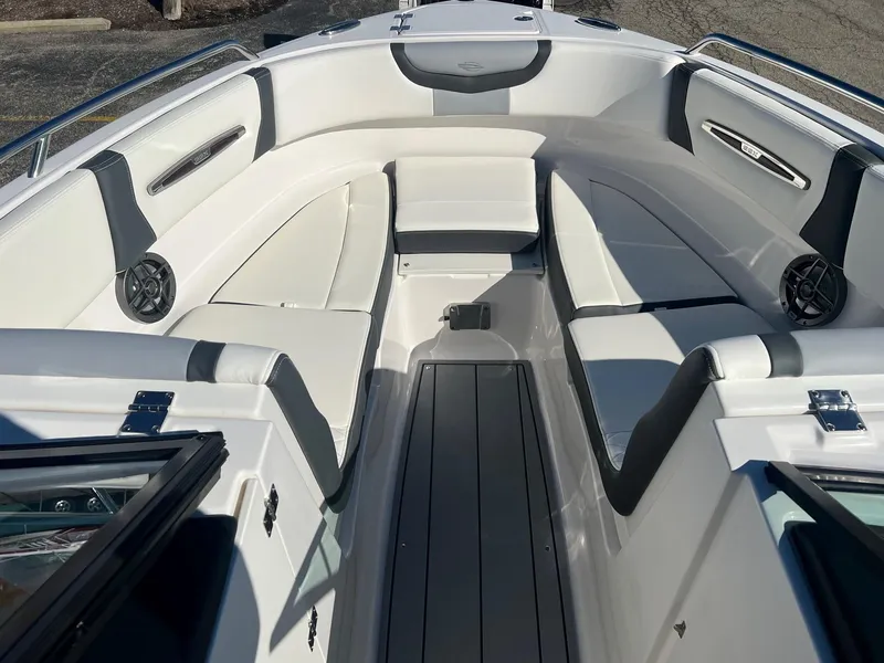 Slide: The Image of 2024 Chaparral 247 SSX boat interior with white seating and sleek design. - 9