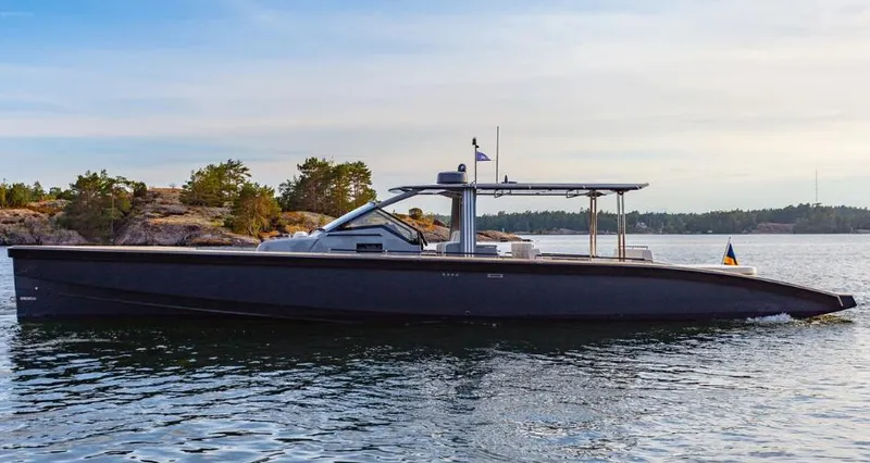 Slide: The Image of 2024 Windy SR52 luxury yacht cruising on a serene lake with scenic background. - 0