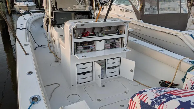 Slide: The Image of 2005 SeaCraft SC32 Master Angler boat with organized storage compartments at a marina. - 10