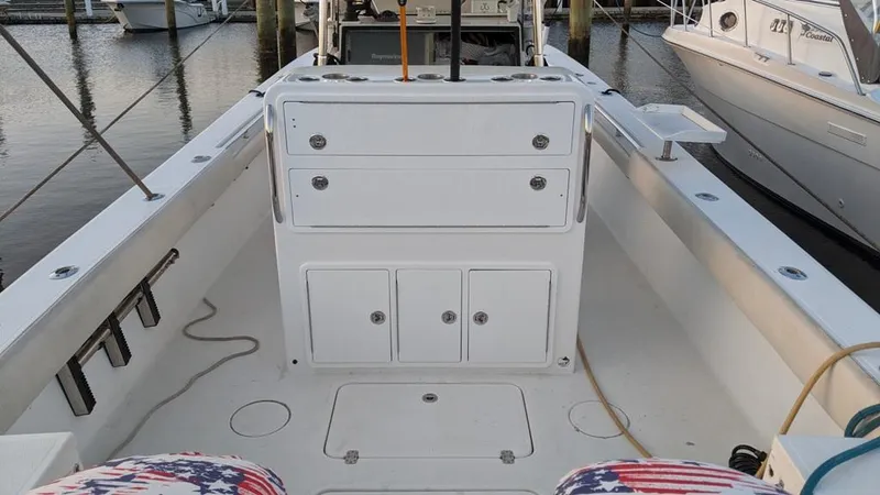 Slide: The Image of 2005 SeaCraft SC32 Master Angler boat interior with storage compartments and fishing rod holders. - 11