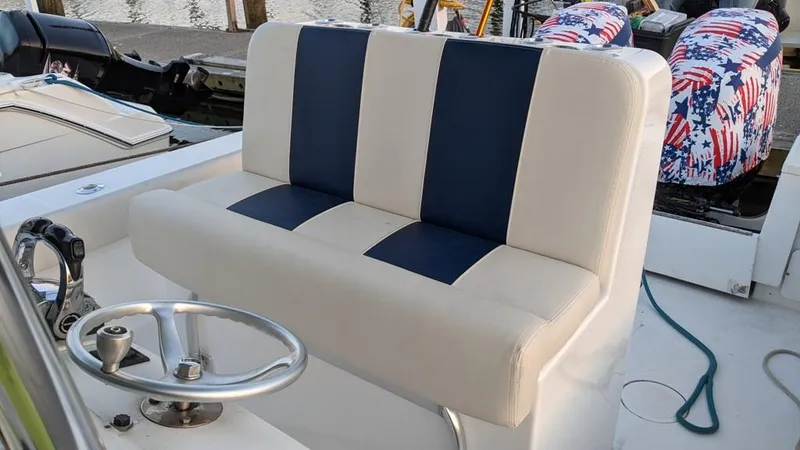 Slide: The Image of 2005 SeaCraft SC32 Master Angler boat with blue and white seating. - 13