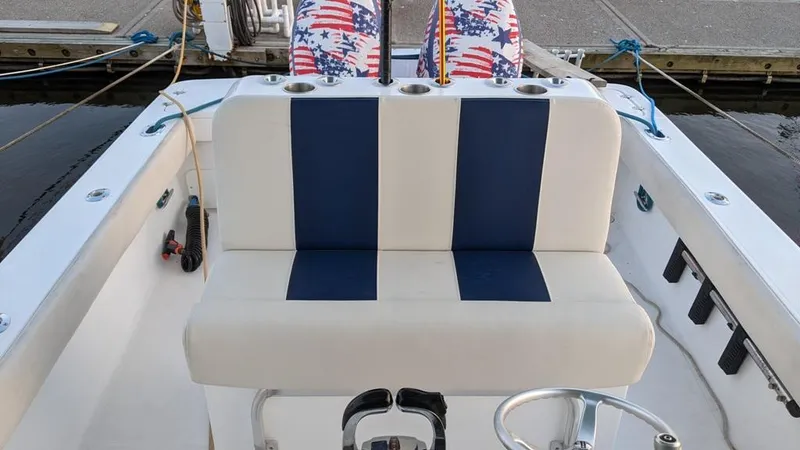 Slide: The Image of 2005 SeaCraft SC32 Master Angler boat interior with striped seating and cup holders. - 15