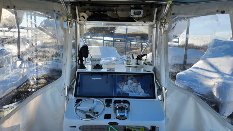 Slide: The Image of 2005 SeaCraft SC32 Master Angler boat cockpit with navigation equipment and clear canopy. - 16