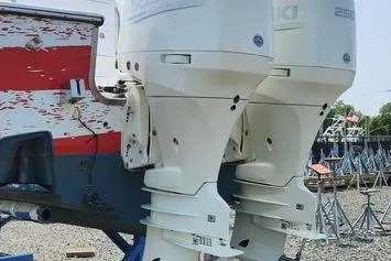 Slide: The Image of 2005 SeaCraft SC32 Master Angler with dual outboard engines, docked on gravel. - 26