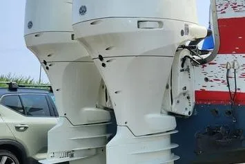 Slide: The Image of Twin outboard motors on a 2005 SeaCraft SC32 Master Angler boat. - 28