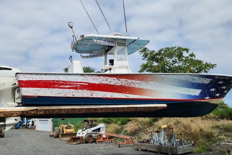 Slide: The Image of 2005 SeaCraft SC32 Master Angler boat with American flag design, docked outdoors. - 3