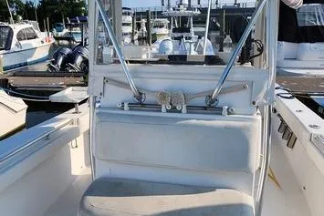 Slide: The Image of 2005 SeaCraft SC32 Master Angler boat interior at marina, featuring seating and control area. - 33