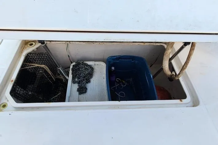 Slide: The Image of Storage compartment on 2005 SeaCraft SC32 Master Angler boat with fishing gear and containers. - 39