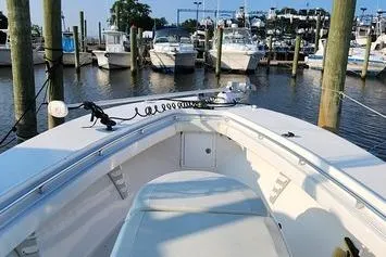 Slide: The Image of 2005 SeaCraft SC32 Master Angler boat docked in a marina, surrounded by other vessels. - 40