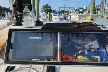 Slide: The Image of 2005 SeaCraft SC32 Master Angler boat dashboard with Raymarine equipment at a marina. - 43