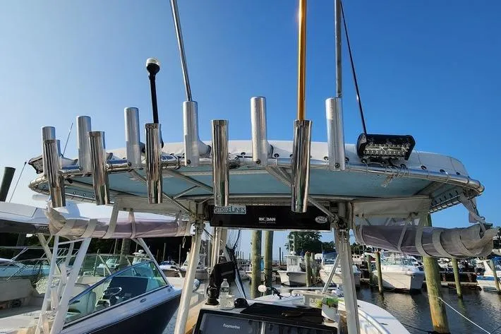 Slide: The Image of 2005 SeaCraft SC32 Master Angler boat with rod holders and canopy at marina. - 45