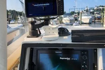Slide: The Image of 2005 SeaCraft SC32 Master Angler dashboard with Humminbird and Raymarine navigation systems. - 47