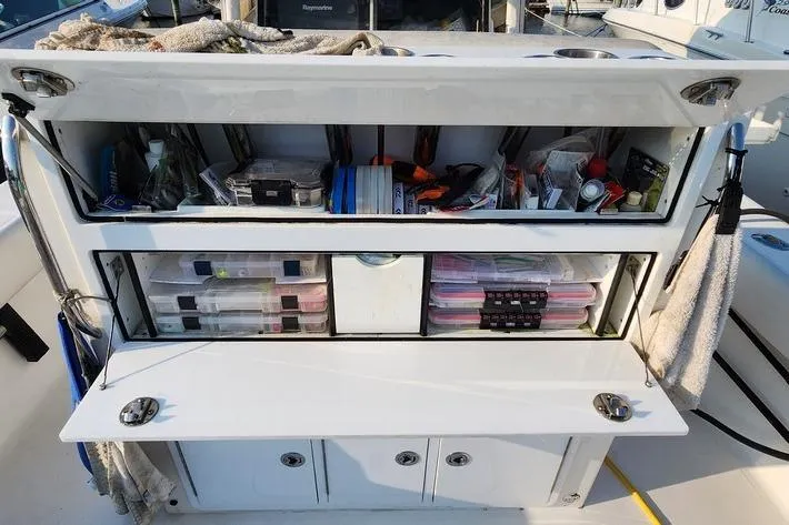 Slide: The Image of Tackle storage on a 2005 SeaCraft SC32 Master Angler boat, organized with various fishing gear. - 52