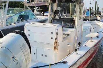 Slide: The Image of 2005 SeaCraft SC32 Master Angler boat docked, featuring dual outboard engines and spacious deck. - 56