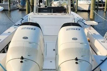 Slide: The Image of 2005 SeaCraft SC32 Master Angler boat with twin 250 horsepower engines docked at a marina. - 57