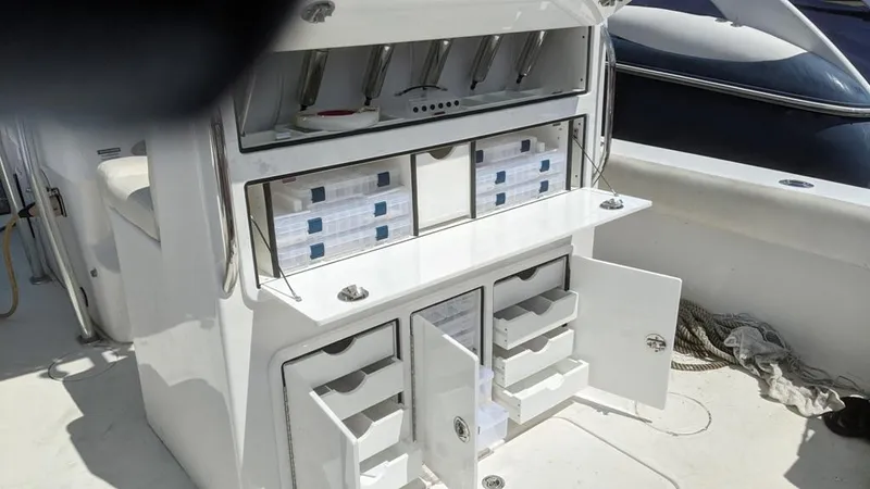 Slide: The Image of 2005 SeaCraft SC32 Master Angler boat with open storage compartments and tackle boxes. - 6