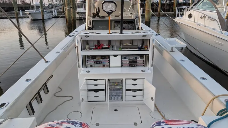 Slide: The Image of 2005 SeaCraft SC32 Master Angler boat with organized fishing gear storage at a marina. - 7